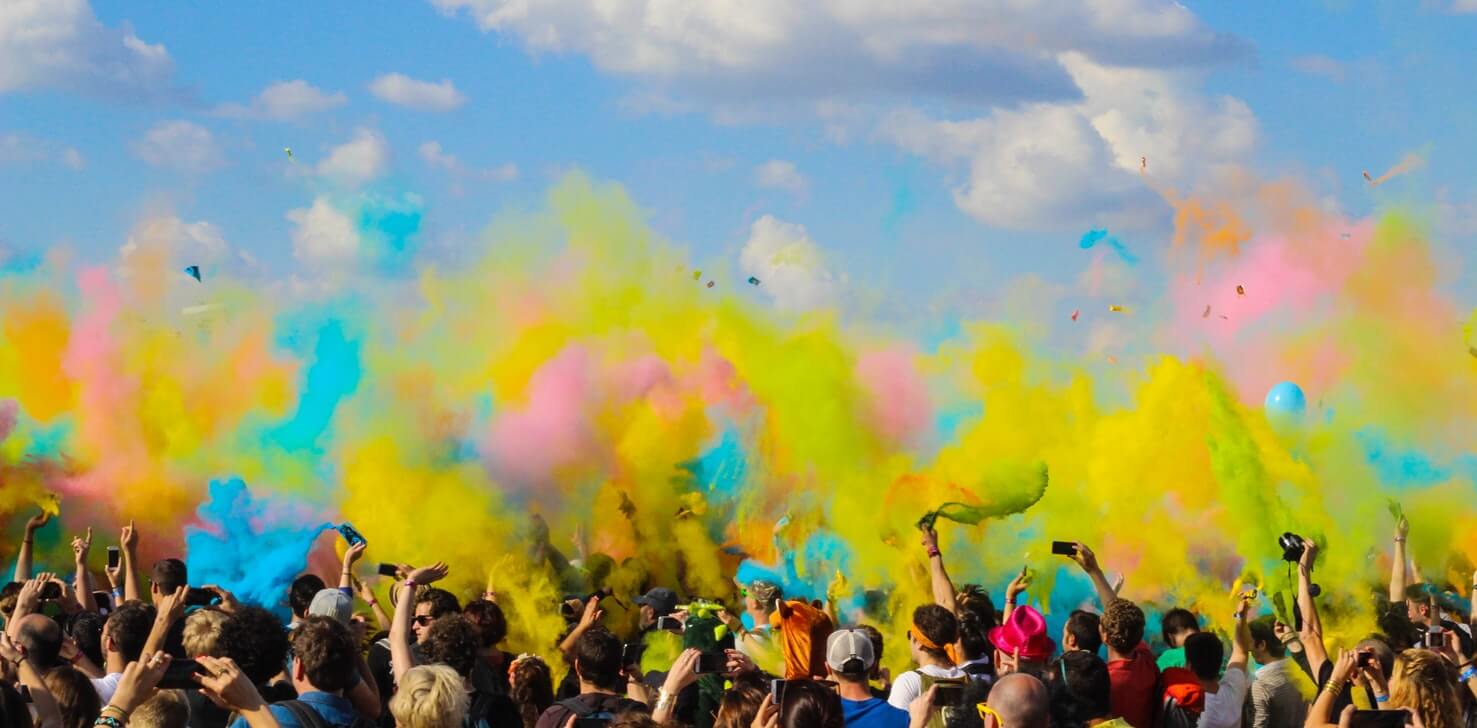 People letting off coloured flares at a festival