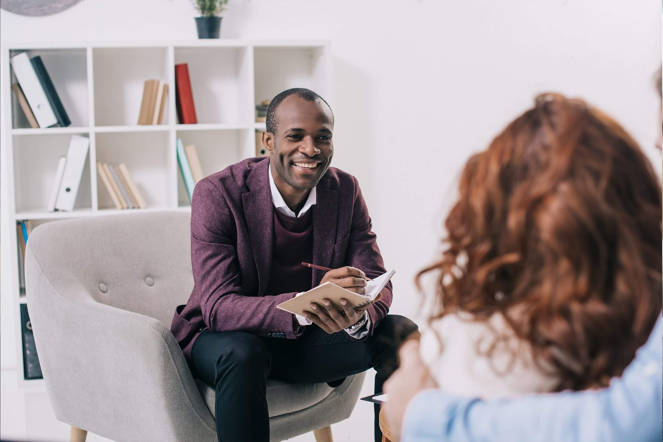 Therapist smiling in counselling session with a couple