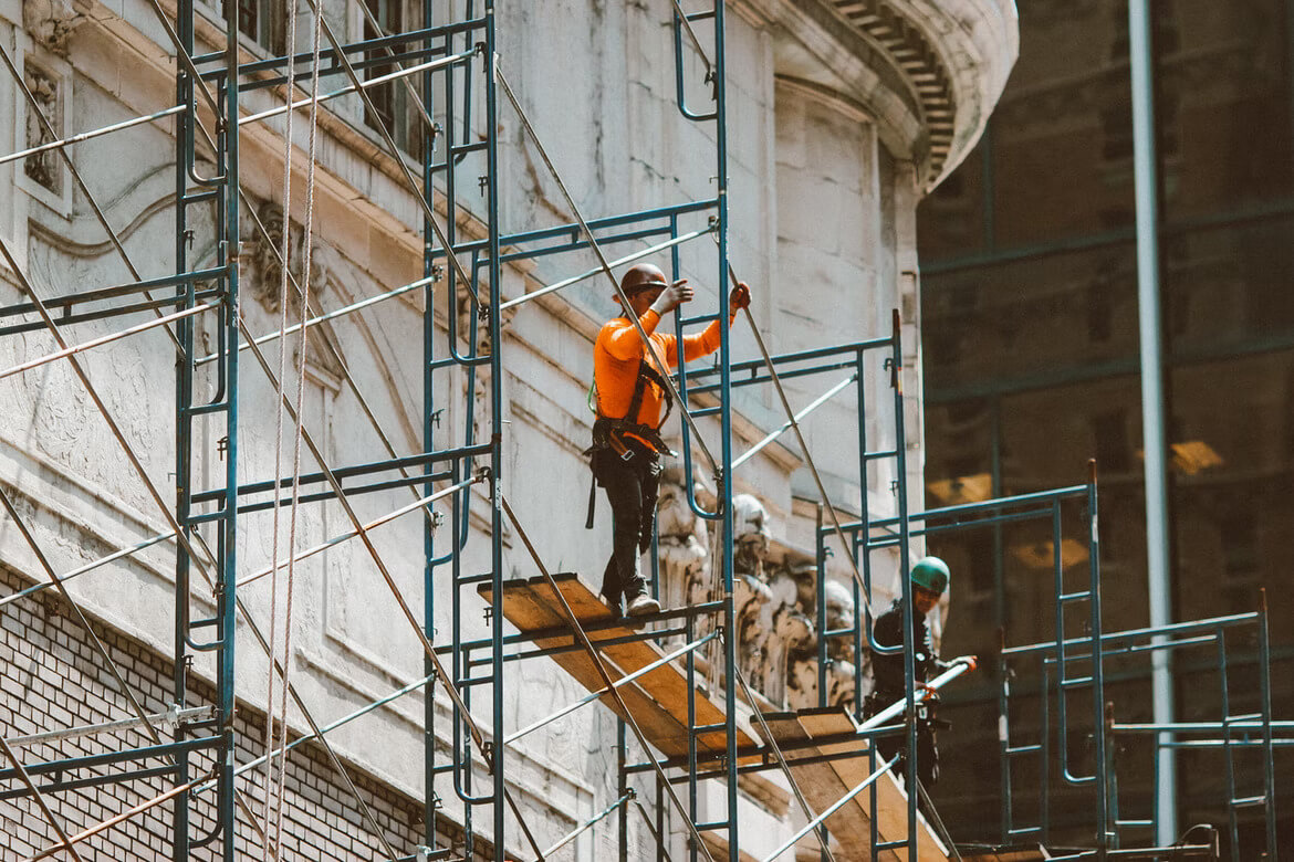 Construction workers setting up scaffolding