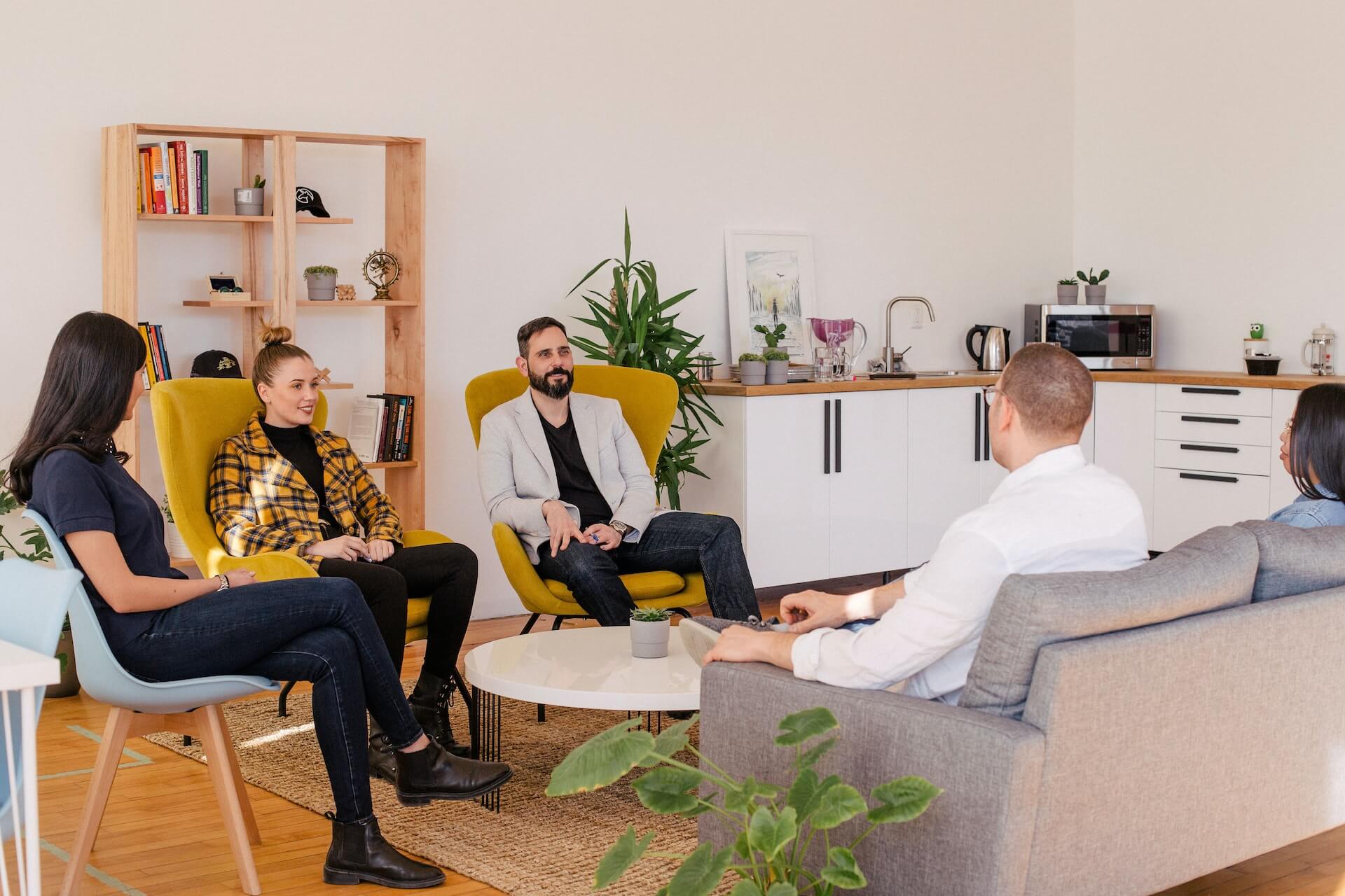 People sitting around a coffee table having a meeting